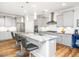 Bright kitchen features a large island with granite counters, stainless steel appliances, and pendant lighting at 1121 Coast Grade St, Wake Forest, NC 27587