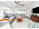 Cozy living space with an open layout, hardwood floors, and ceiling fan above at 1121 Coast Grade St, Wake Forest, NC 27587