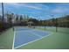 Community pickleball courts with covered seating areas, surrounded by trees at 1121 Coast Grade St, Wake Forest, NC 27587