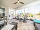 Tiled sunroom with plenty of natural light and comfortable lounge furniture at 1121 Coast Grade St, Wake Forest, NC 27587
