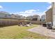 Fenced backyard with a pergola swing set, stone fire pit area, and a patio with an outdoor dining set at 114 Red Robin Rd, Durham, NC 27703