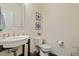 A half bath featuring elegant fixtures and charming coastal-themed decor at 114 Red Robin Rd, Durham, NC 27703