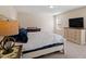 Relaxing bedroom featuring carpet, large bed, and natural light at 114 Red Robin Rd, Durham, NC 27703