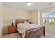 A bright bedroom with a wooden bed frame and natural light at 114 Red Robin Rd, Durham, NC 27703