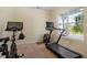 Bright home exercise room featuring a stationary bike, treadmill, and lots of natural light at 114 Red Robin Rd, Durham, NC 27703