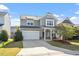 Inviting two-story home featuring a two-car garage, covered porch, and charming curb appeal at 114 Red Robin Rd, Durham, NC 27703