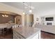 Open concept kitchen features granite counters, island with pendant lighting, and view into the living area at 114 Red Robin Rd, Durham, NC 27703