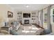 Bright living room with fireplace, built-ins, plush seating, and access to outdoor space at 114 Red Robin Rd, Durham, NC 27703