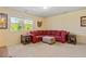 Spacious living room with comfortable red sofa, ottoman, and natural light at 114 Red Robin Rd, Durham, NC 27703