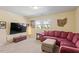 Cozy living room with plush red sectional and large screen TV at 114 Red Robin Rd, Durham, NC 27703