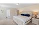 A serene main bedroom featuring neutral tones, a queen bed, and ensuite access at 114 Red Robin Rd, Durham, NC 27703