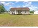 Expansive backyard featuring a well-maintained lawn and the home's rear exterior at 116 Meade Dr, Four Oaks, NC 27524