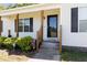 Inviting front entry with covered porch, security system, and well-manicured landscaping at 116 Meade Dr, Four Oaks, NC 27524
