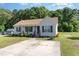 Attractive single-story home with landscaped front yard, sidewalk, and covered entryway at 116 Meade Dr, Four Oaks, NC 27524