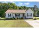 Charming single-story home with manicured lawn, traditional facade, and inviting front porch at 116 Meade Dr, Four Oaks, NC 27524