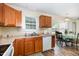 Kitchen with wood cabinets, countertop and appliances along with a table with seating near a window at 116 Meade Dr, Four Oaks, NC 27524