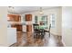 Eat-in kitchen with wood cabinets, wood-look floors and table with seating near large bay window at 116 Meade Dr, Four Oaks, NC 27524