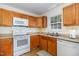 Kitchen features wood cabinets and countertop with appliances and wood-look floors at 116 Meade Dr, Four Oaks, NC 27524
