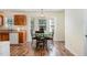 Eat-in kitchen with wood cabinets, wood-look floors and table with seating near a large bay window at 116 Meade Dr, Four Oaks, NC 27524