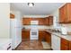 Kitchen with wood cabinets, countertop, and appliances along with wood-look floors at 116 Meade Dr, Four Oaks, NC 27524