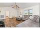 Bright living room with vaulted ceiling, wood flooring, and neutral-toned sectional sofa at 116 Meade Dr, Four Oaks, NC 27524