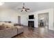 Living room with wood floors, fireplace, and view into the dining area at 116 Meade Dr, Four Oaks, NC 27524