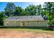 The back of the house with large windows and a sliding glass door at 116 Shawnee Dr, Louisburg, NC 27549