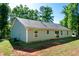 Back of the single Gathering home featuring a flat back yard and well-manicured lawn at 116 Shawnee Dr, Louisburg, NC 27549