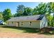 Rear view of a home featuring a flat yard, windows, and an entry door at 116 Shawnee Dr, Louisburg, NC 27549