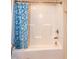 Detail of a standard bathtub with a blue and grey shower curtain at 116 Shawnee Dr, Louisburg, NC 27549
