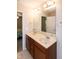 Bathroom featuring double sinks, framed mirrors, and wood cabinets at 116 Shawnee Dr, Louisburg, NC 27549