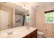 Bathroom featuring double sinks, framed mirrors, and a combined shower and tub at 116 Shawnee Dr, Louisburg, NC 27549