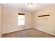 A neutral-toned bedroom with a window and wall decor at 116 Shawnee Dr, Louisburg, NC 27549