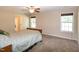 Bedroom featuring neutral walls, carpeted floors, and a cozy bed with two windows at 116 Shawnee Dr, Louisburg, NC 27549