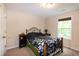 Bedroom featuring carpeted floors, a dark metal bedframe, and neutral colored walls at 116 Shawnee Dr, Louisburg, NC 27549