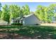 Ranch home with beautiful lawn and mature trees offering a peaceful, shaded atmosphere at 116 Shawnee Dr, Louisburg, NC 27549