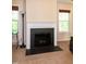 Elegant fireplace with a white mantle and black hearth, flanked by bright windows at 116 Shawnee Dr, Louisburg, NC 27549