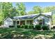 Charming single-story home featuring a well-manicured lawn and an attached garage at 116 Shawnee Dr, Louisburg, NC 27549