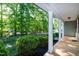 Charming front porch featuring stately columns and a peaceful view of the lush, tree-lined yard at 116 Shawnee Dr, Louisburg, NC 27549