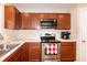 Kitchen featuring stainless steel appliances, wood cabinets, and stone countertops at 116 Shawnee Dr, Louisburg, NC 27549
