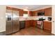 Modern kitchen with stainless steel appliances, dark wood cabinets and sleek countertops at 116 Shawnee Dr, Louisburg, NC 27549