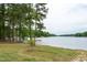 Breathtaking lake views surrounded by mature trees, offering a peaceful retreat near the community at 116 Shawnee Dr, Louisburg, NC 27549