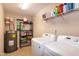 Well-organized laundry room with washer, dryer, and storage shelves at 116 Shawnee Dr, Louisburg, NC 27549