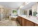 Bright bathroom featuring double vanity, a corner tub, and a glass-enclosed shower at 1204 Caribou Xing, Durham, NC 27713
