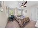 Cozy bedroom with a ceiling fan, large window views and natural light at 1204 Caribou Xing, Durham, NC 27713