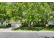 Well-maintained two-story home with a two-car garage, framed by mature trees and landscaping at 1204 Caribou Xing, Durham, NC 27713