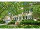 Charming two-story home with a manicured lawn, lush landscaping, and inviting entrance at 1204 Caribou Xing, Durham, NC 27713