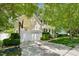Two-story home with a white two-car garage, basketball hoop, and well-manicured front yard at 1204 Caribou Xing, Durham, NC 27713