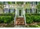 Charming front entrance with brick steps, white railings, and manicured greenery at 1204 Caribou Xing, Durham, NC 27713