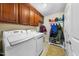 Functional laundry room equipped with washer, dryer, and storage cabinets for convenience at 1204 Caribou Xing, Durham, NC 27713
